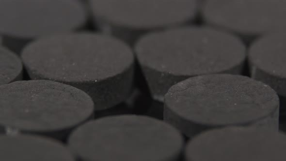 Black Pills for Immunity, Health, Rotation, Close Up, Reflection, Top View alt