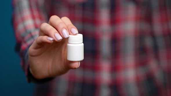 Woman Presenting a Hand Pills alt