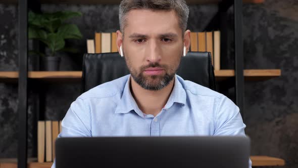 Man Trader Broker Works for Laptop Looks at Chart on Stock Exchange in Office alt