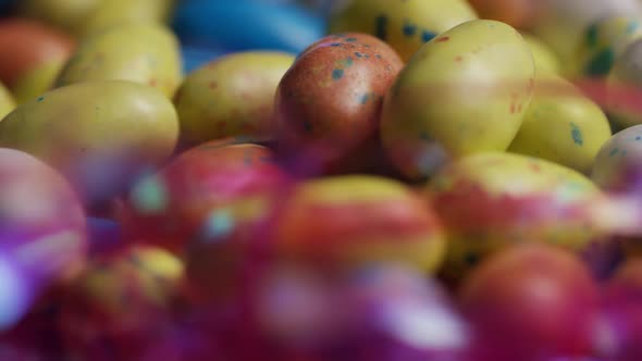 Rotating shot of colorful Easter candies on a bed of easter grass alt