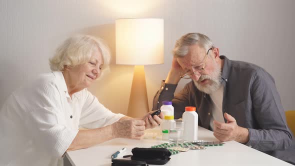 Senior Couple Using Glucometer For Blood Sugar Monitoring