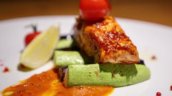 Delicious salmon fillet grilled for lunch and served with vegetables on table alt