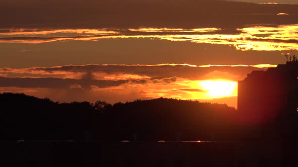 Timelapse of Sunset Over Trees and Building alt
