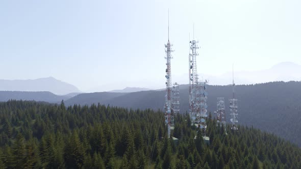 Antennas complex on a forested hill. Radio masts and towers for broadcasting. alt