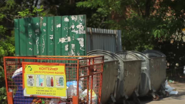 A Man Throws Garbage in the Trash. Kyiv. Ukraine alt