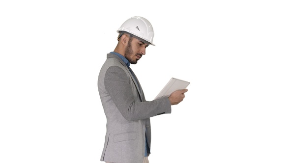 Engineer walking and working on digital tablet on white background alt