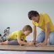 Father and His Little Son Install Laminate on the Floor in Their Apartment - VideoHive Item for Sale