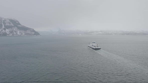 Aerial View Of Ferry Cruising From Olderdalen To Lyngseidet On Foggy Kaafjord, Norway - drone shot alt