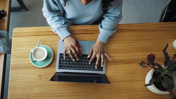 Female African hands typing on laptop alt