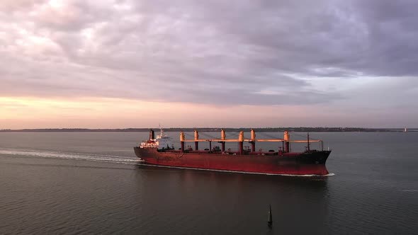 Tracking Aerial of Cargo Bulker on Its Tranportation Voyage During Sunset alt