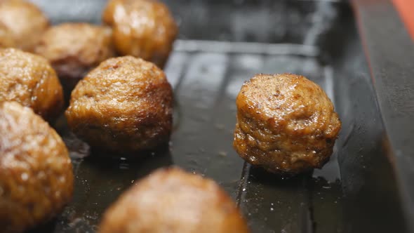 Fried Round Meatballs on a Metal Pan Dolly Shot Closeup