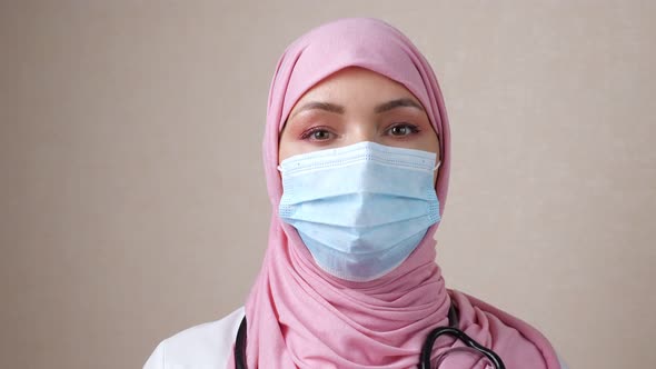 Female Doctor in Hijab with a Phonendoscope Around Neck and a Mask on Face alt