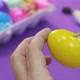 Happy Easter Close Up. White man painting a yellow Easter egg with a brush - VideoHive Item for Sale