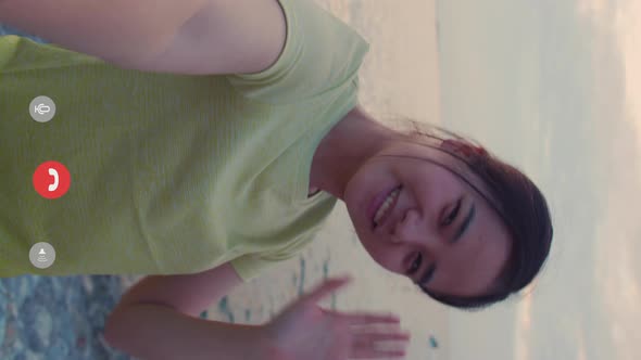 Vertical portrait of young sportswoman using smartphone video call with friends. alt