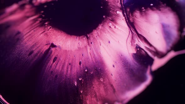 Macro Footage of Ethereal Pink Paint and Glitter Particles Spreading alt