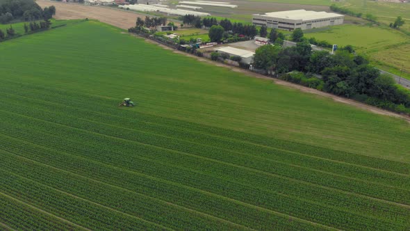 Aerial: Tractor Working on Cultivated Fields Farmland, Industrial Agriculture Occupation alt