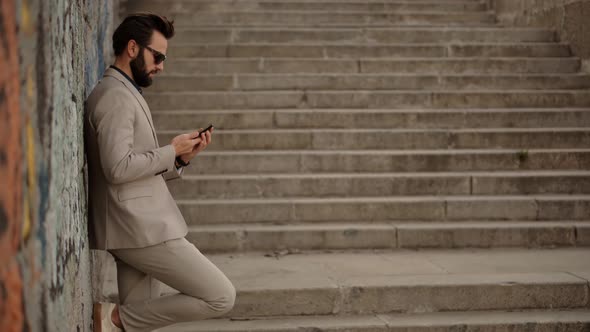 Businessman Working Outdoors.Man Talking On Mobile Phone With Friend.Man Talking By Smartphone alt