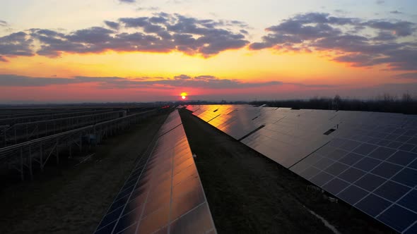 Aerial view of Solar Panel at Sunrise produces Green Energy. Ecology Concept alt