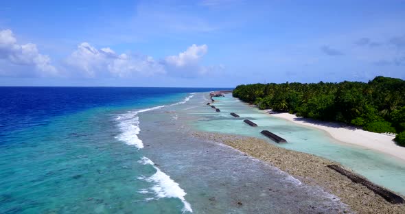 Beautiful fly over abstract shot of a white sandy paradise beach and aqua blue ocean background alt