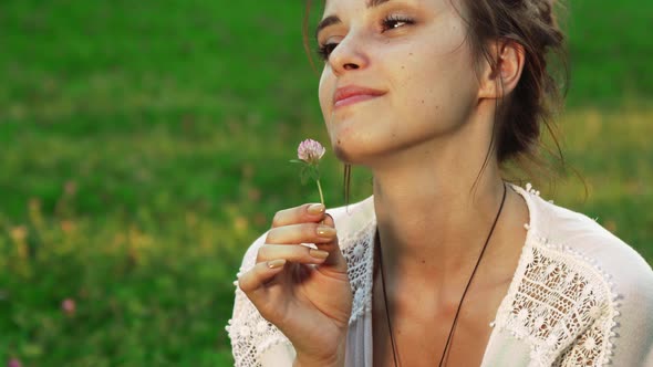 Girl Is Sniffing a Flower alt