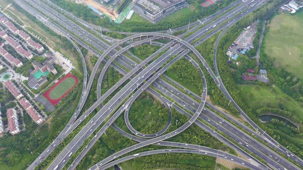 Aerial view of highway and overpass in city alt