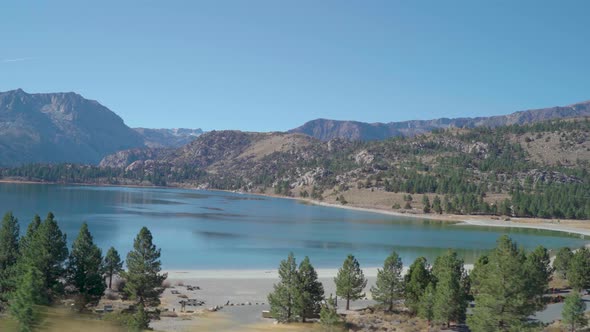 Tracking Shot of Alpine Mountain Lake on Clear Sunny Day Left to Right