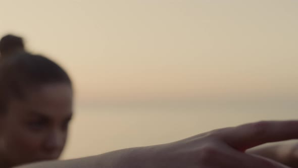 Woman Performing Warrior Three Pose on Beach Close Up alt