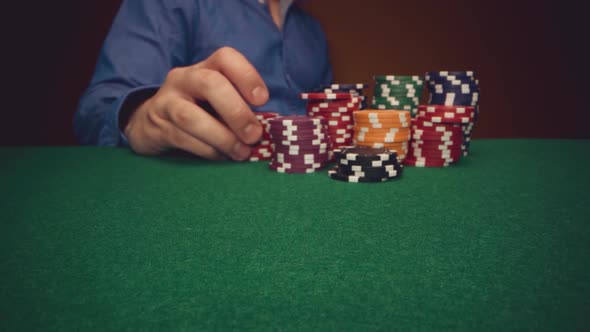 Male Player Betting All Chips in While Playing in Casino Close Up