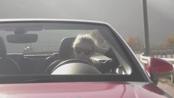 Girl Sitting Into Red Cabriolet at Mountains. Summer Vacation Mood.