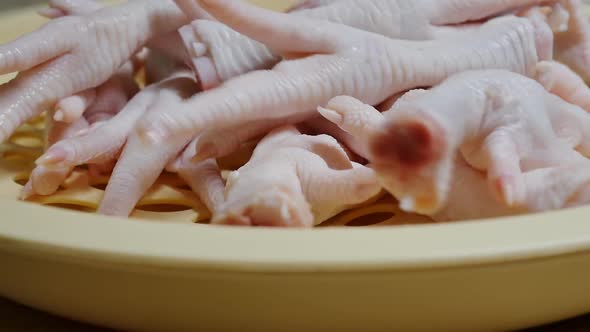 Put Raw Chicken Feet in a Plastic Bowl Before Frying