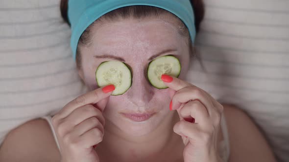 Woman Puts Cucumbers on Her Eyes Cosmetic Mask Skin Care at Home