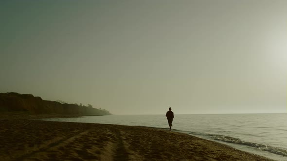 Silhouette Jogger Woman Training on Sandy Beach alt