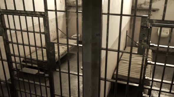 Endless footage of dark dirty cinematic single prison cell block. Side view. alt