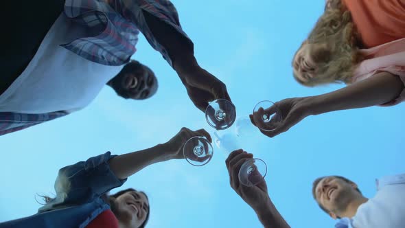 Base View of Multiracial Friends Clinking Champagne Glasses, Celebration