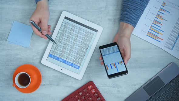 Businessman Using Mobile Phon And Tablet With Financial Data alt