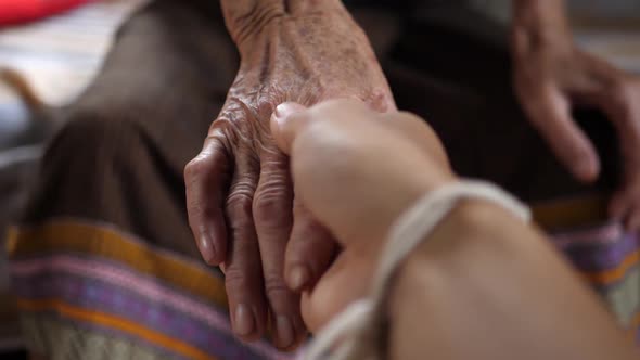 Man Holding His Grandmother's Hand alt