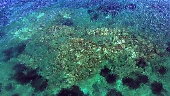 Small Islet Island Formed by the Accumulation of Rock Deposits Atop a Reef in the Sea alt