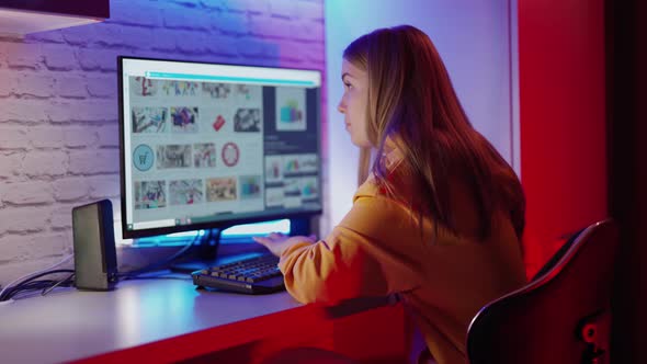 Girl using computer in room, Female student using computer at home alt