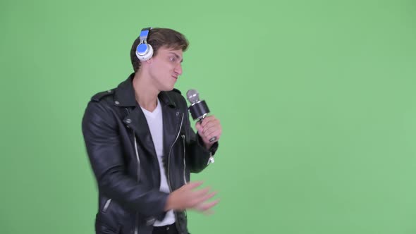 Happy Young Rebellious Man Singing While Listening To Music alt