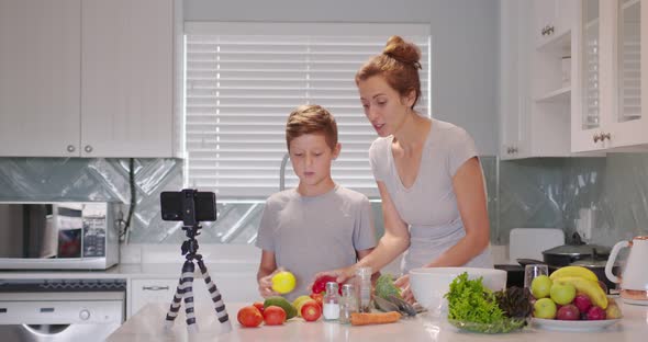 Food Blogger Woman and a Child Boy Talking About Healthy Food to the Camera Food Vlog alt