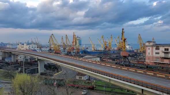 Slow Motion Panning View of Maritime Port with Overpass Road and Cargo Railway Under