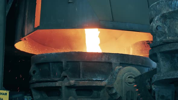 Molten Steel is Pouring Into an Industrial Barrel alt