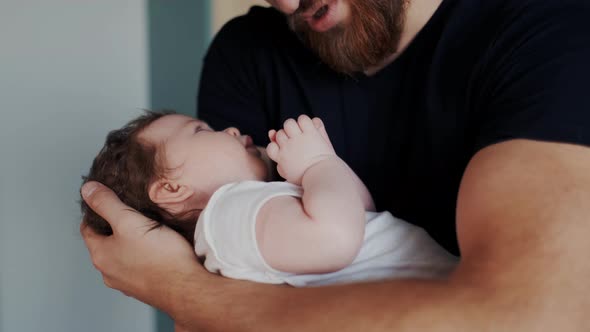 Carefree Adorable Child Lying on Father Hands alt
