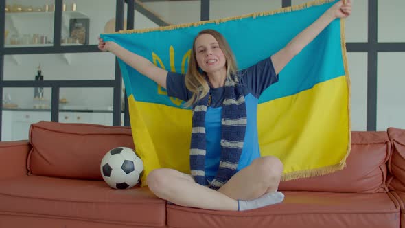 Lovely Female Football Fan Watching Match on Tv and Singing National Anthem alt