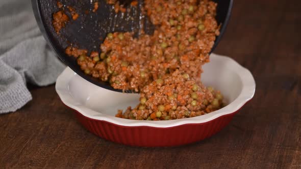 A Minced Meat and Vegetable Mixture Being Placed to a Baking Pan