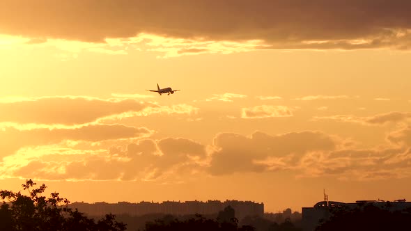 Airplane is Landing at Sunset alt