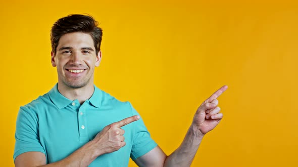 Copy Space Portrait of Smiling Man in Blue Indicates with Hands on Left Up Side. Guy Presenting and alt