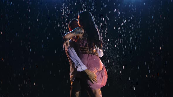 Happy Lovers Perform Dance of Passion in Rain and Enjoy Each Other alt