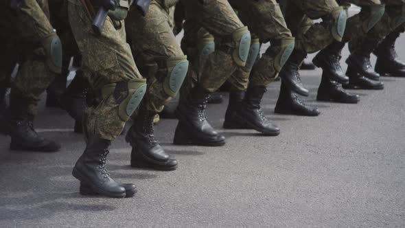 Military Men in Camouflage March on the Spot in the City Square During a Military Parade