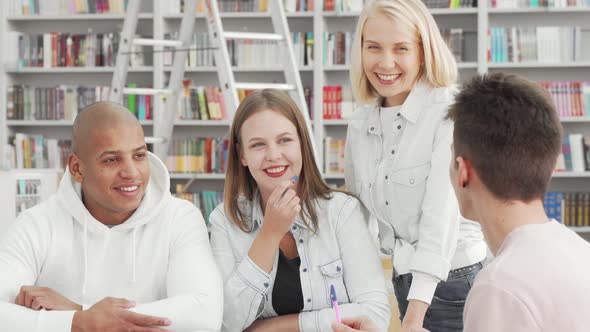 Cheerful Young People Enjoying Talking at the College Library After Studying alt
